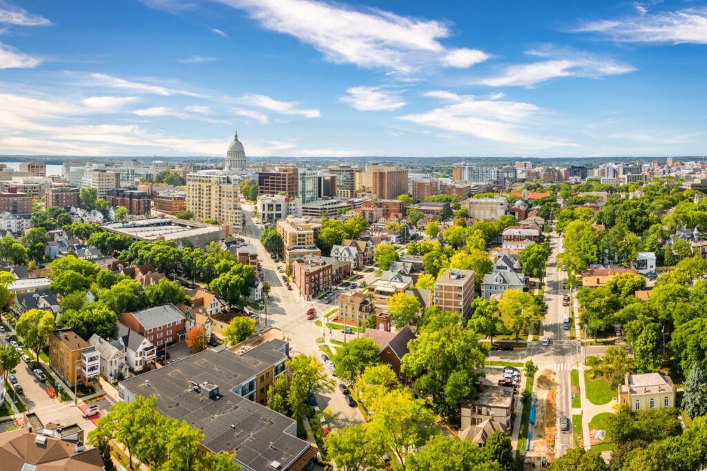 Aerial view of city with trees and buildings.