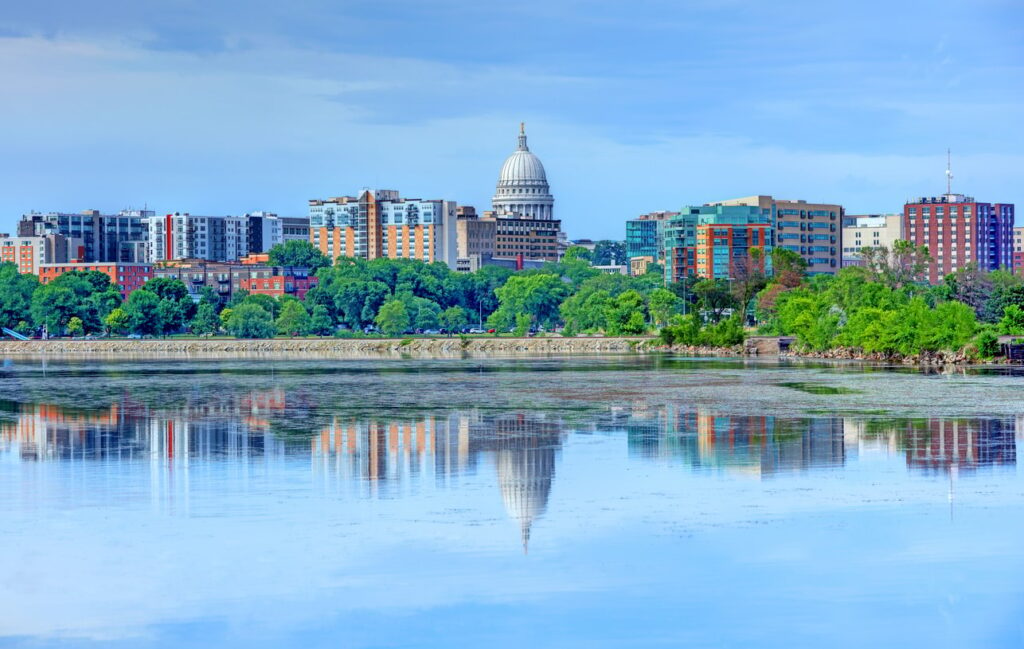 Capitol building reflected in lake, Madison skyline view.