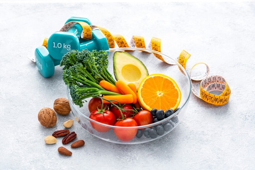 Healthy foods with weights and measuring tape