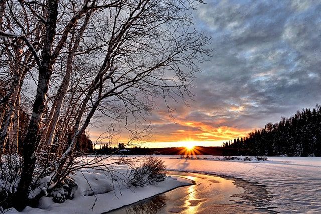 Winter sunset over a snowy river